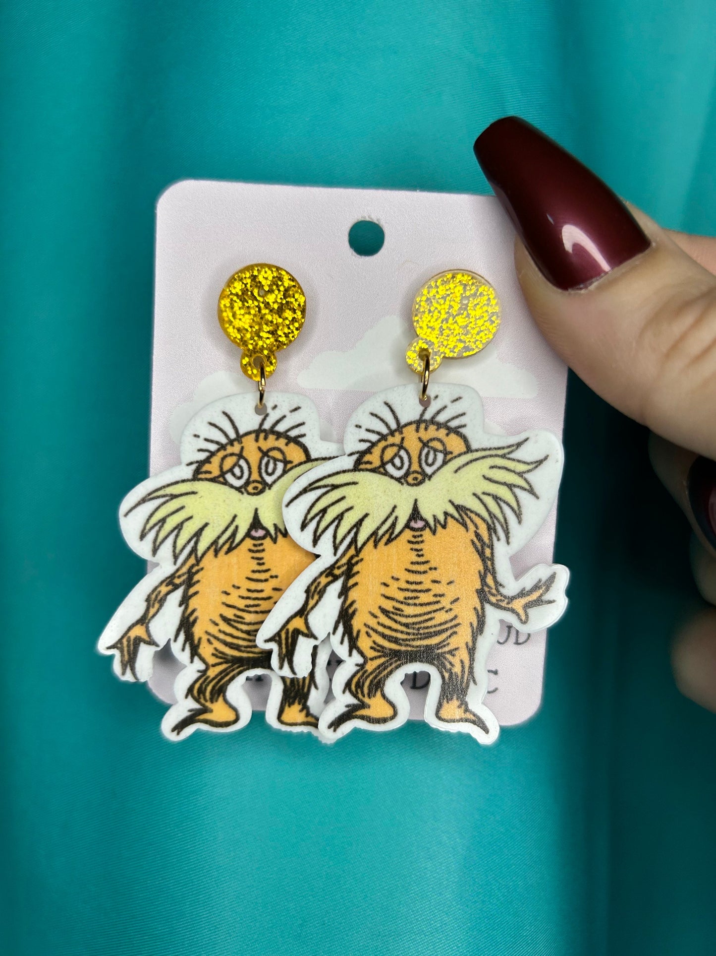 Lorax earrings with bronze glitter circle push back posts in silver dr Seuss
