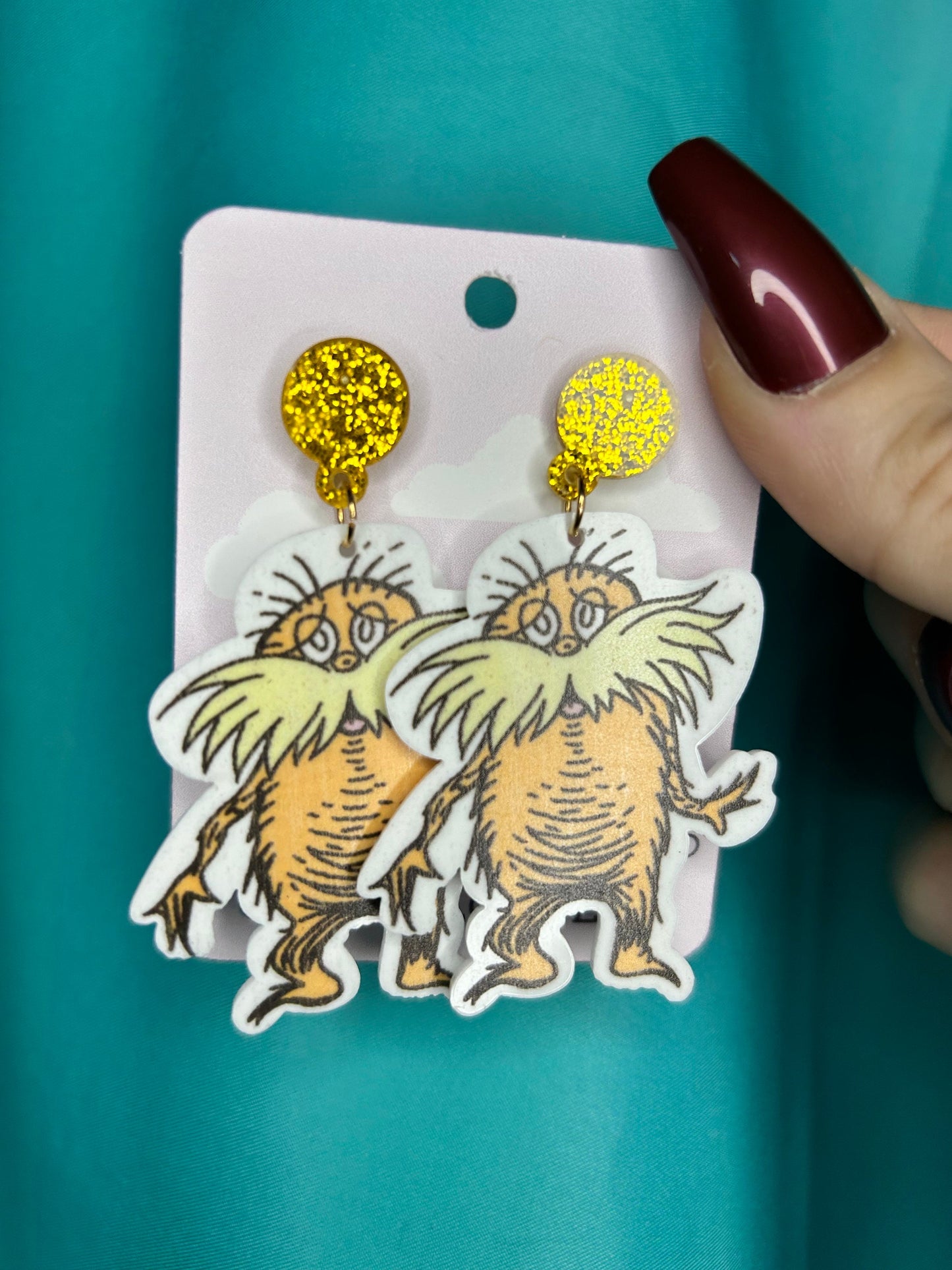 Lorax earrings with bronze glitter circle push back posts in silver dr Seuss