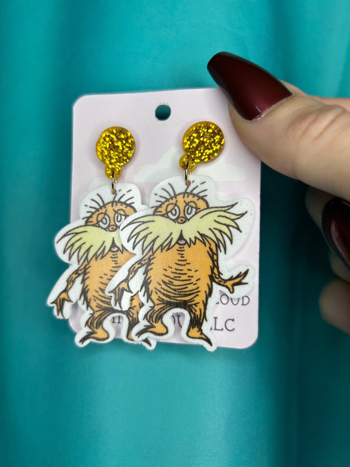 Lorax earrings with bronze glitter circle push back posts in silver dr Seuss