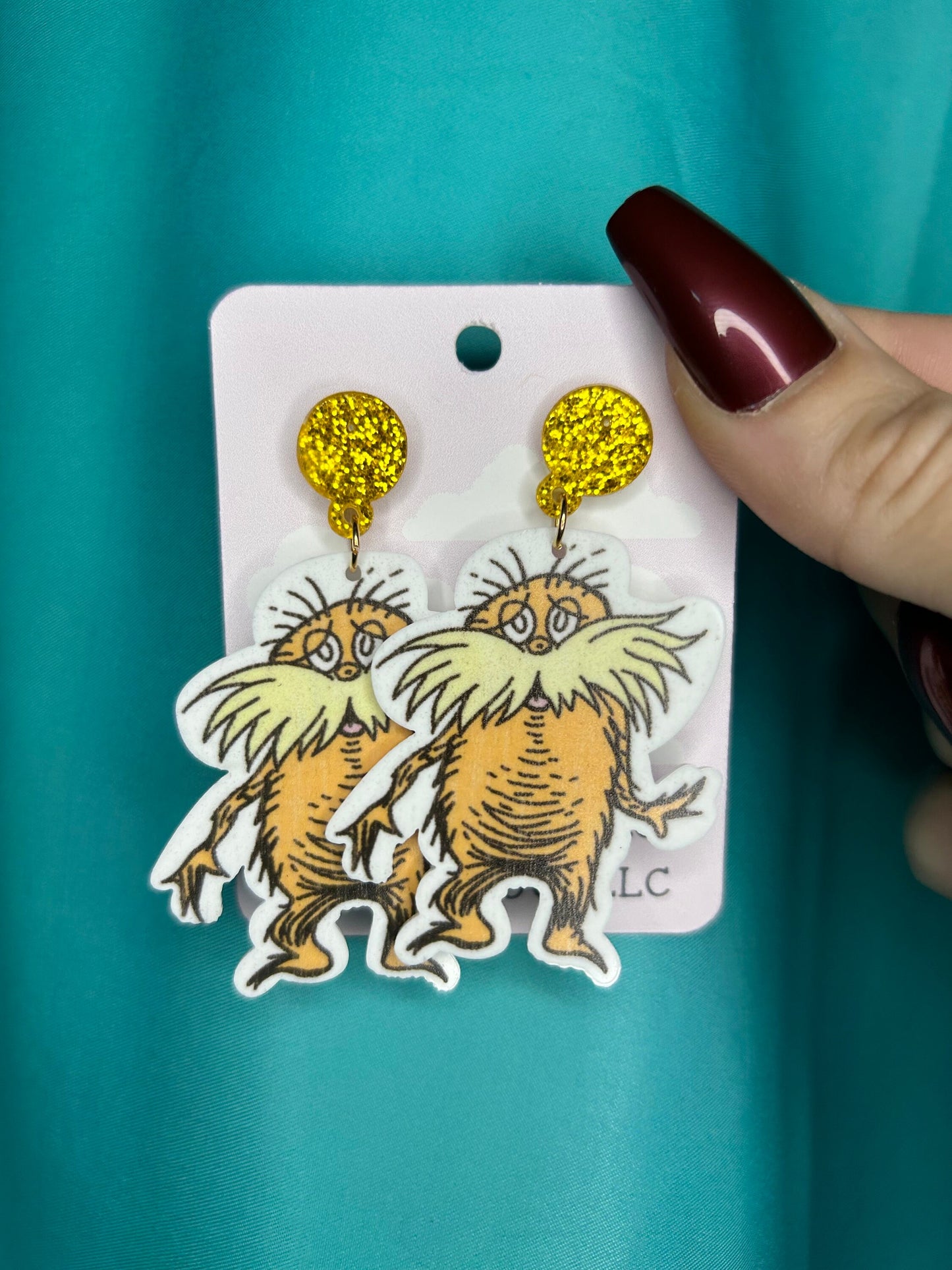 Lorax earrings with bronze glitter circle push back posts in silver dr Seuss